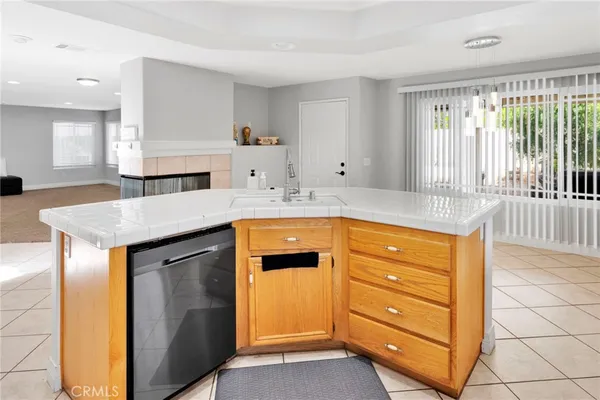 a view of a livingroom with a fireplace and window