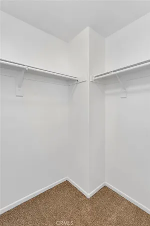 an empty room with a fireplace and windows