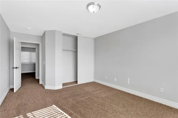 a spacious bathroom with a shower sink and mirror