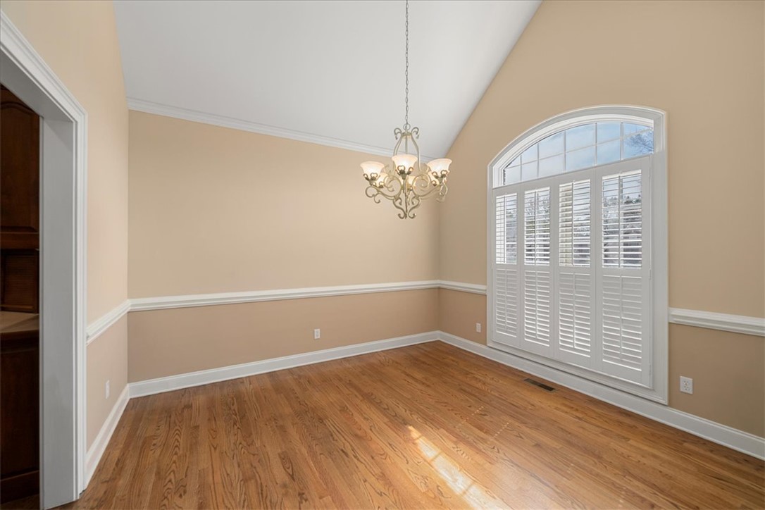 128 Cayman Way Anderson, SC 29621 - Photo 18 of 48 This spacious dining room features hardwood floors, vaulted ceilings, and a beautiful arched window.