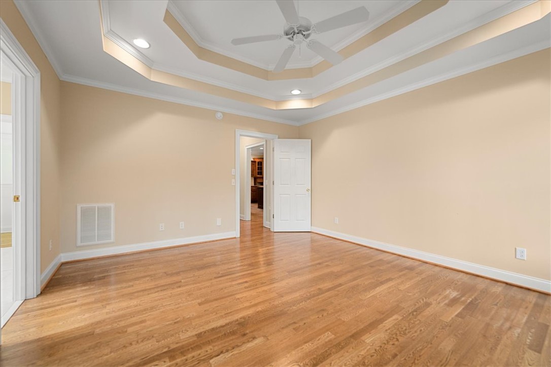 128 Cayman Way Anderson, SC 29621 - Photo 21 of 48 This spacious bedroom offers gleaming hardwood floors and elegant tray ceilings.