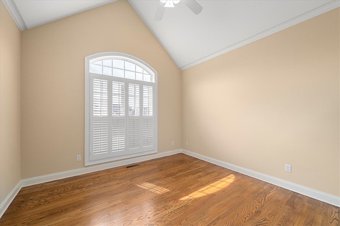 128 Cayman Way Anderson, SC 29621 - Photo 26 of 48 This spacious room features vaulted ceilings and rich hardwood floors, creating an inviting atmosphere.