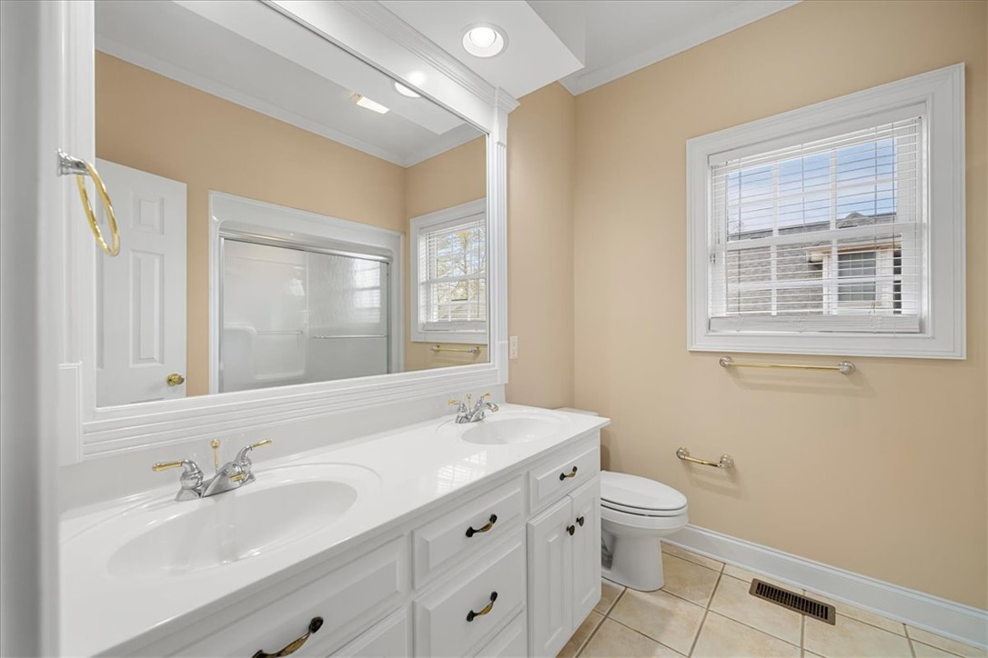 128 Cayman Way Anderson, SC 29621 - Photo 28 of 48 This bathroom features a double vanity and sleek tiled flooring.