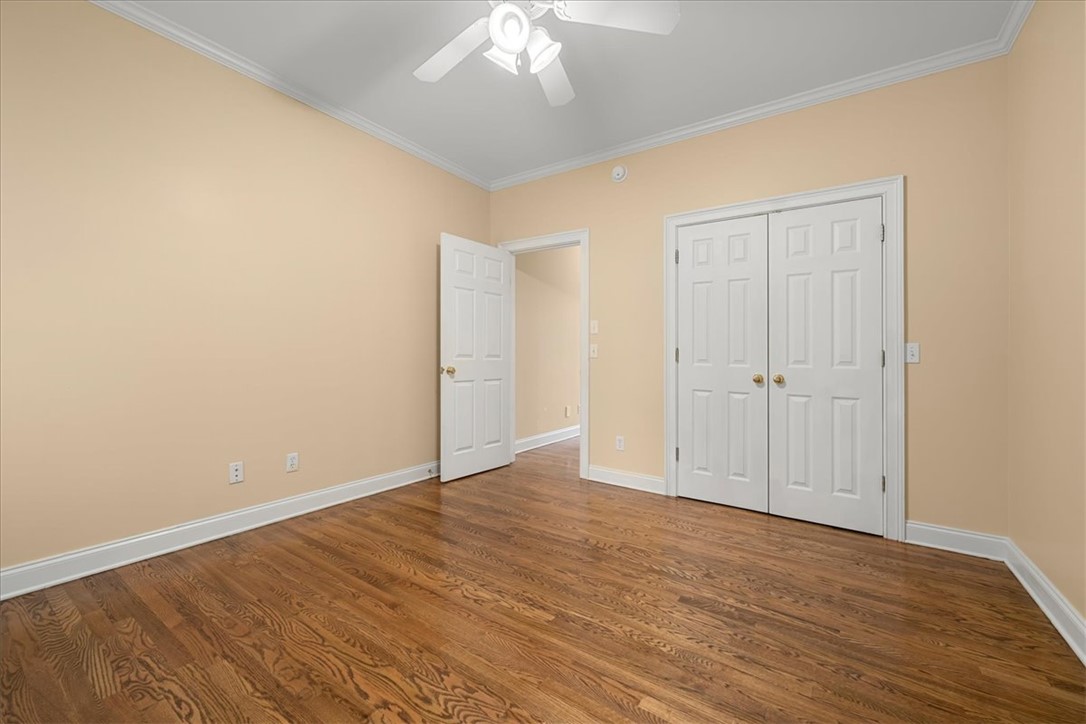 128 Cayman Way Anderson, SC 29621 - Photo 30 of 48 This spacious room features rich hardwood flooring and elegant crown molding throughout.
