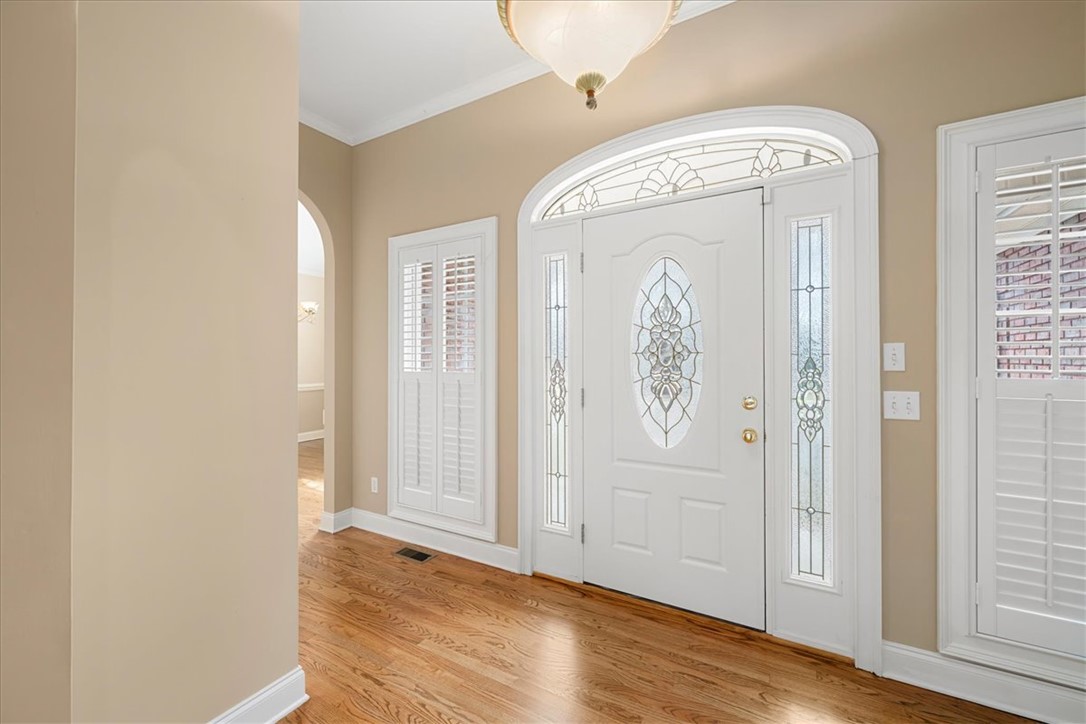 128 Cayman Way Anderson, SC 29621 - Photo 3 of 48 This entry features classic hardwood flooring and a beautifully designed door with elegant glass accents.
