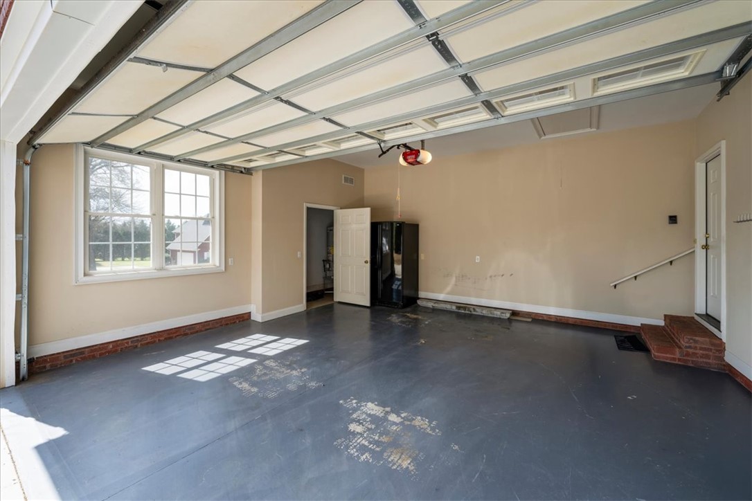 128 Cayman Way Anderson, SC 29621 - Photo 32 of 48 This spacious garage offers ample room for vehicles and storage, featuring a functional design.