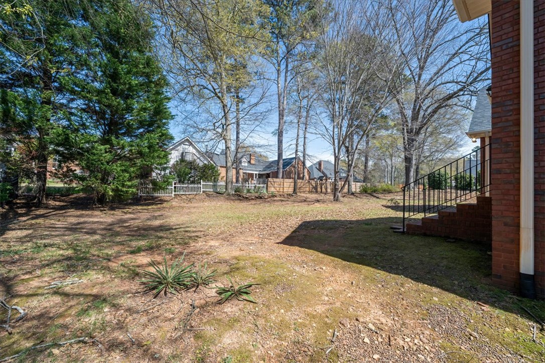 128 Cayman Way Anderson, SC 29621 - Photo 35 of 48 This spacious yard offers ample outdoor living potential, surrounded by natural beauty and privacy.