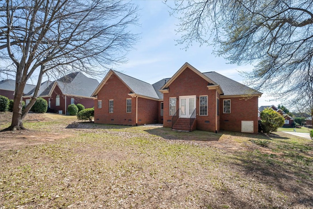 128 Cayman Way Anderson, SC 29621 - Photo 37 of 48 This classic brick residence features an inviting back entrance with French doors leading to a spacious yard.