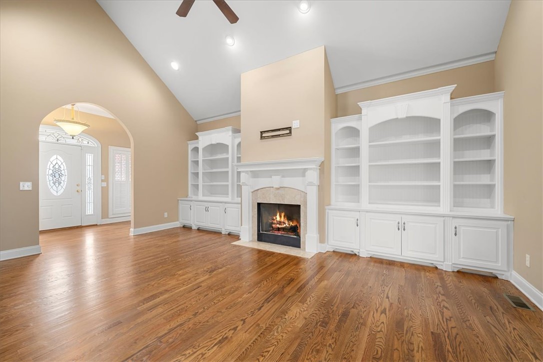 128 Cayman Way Anderson, SC 29621 - Photo 4 of 48 This inviting living area boasts rich hardwood flooring and a warm fireplace.