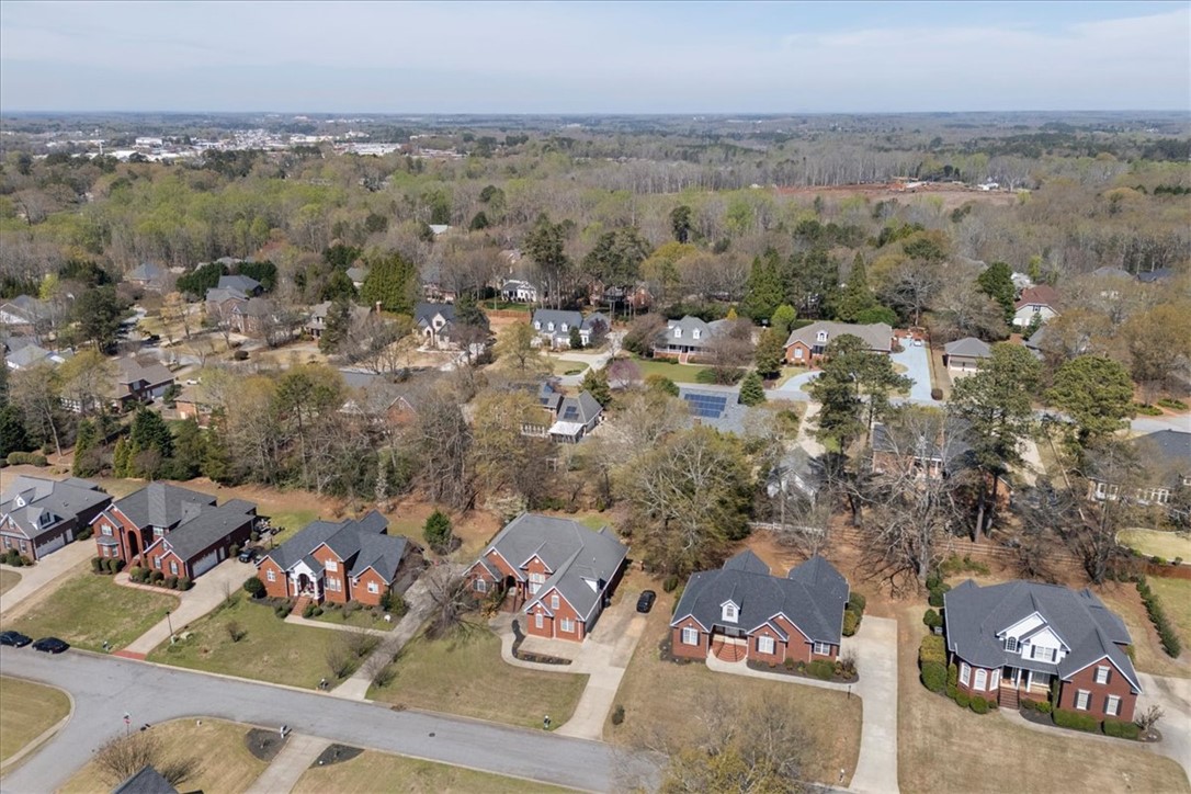 128 Cayman Way Anderson, SC 29621 - Photo 41 of 48 This panoramic view showcases a serene neighborhood setting with mature trees and traditional brick residences.