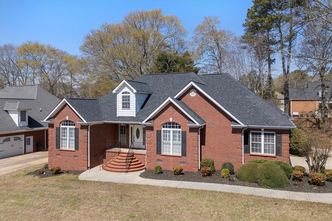 128 Cayman Way Anderson, SC 29621 - Photo 46 of 48 This brick residence features charming dormer windows and a well-maintained front entrance.
