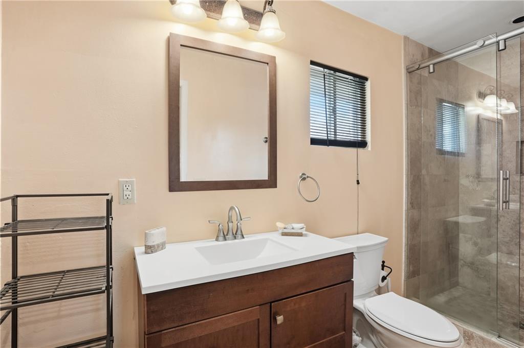 8926 Ashton Road Jonesboro, GA 30238 - Photo 11 of 32 a bathroom with a sink toilet vanity and shower