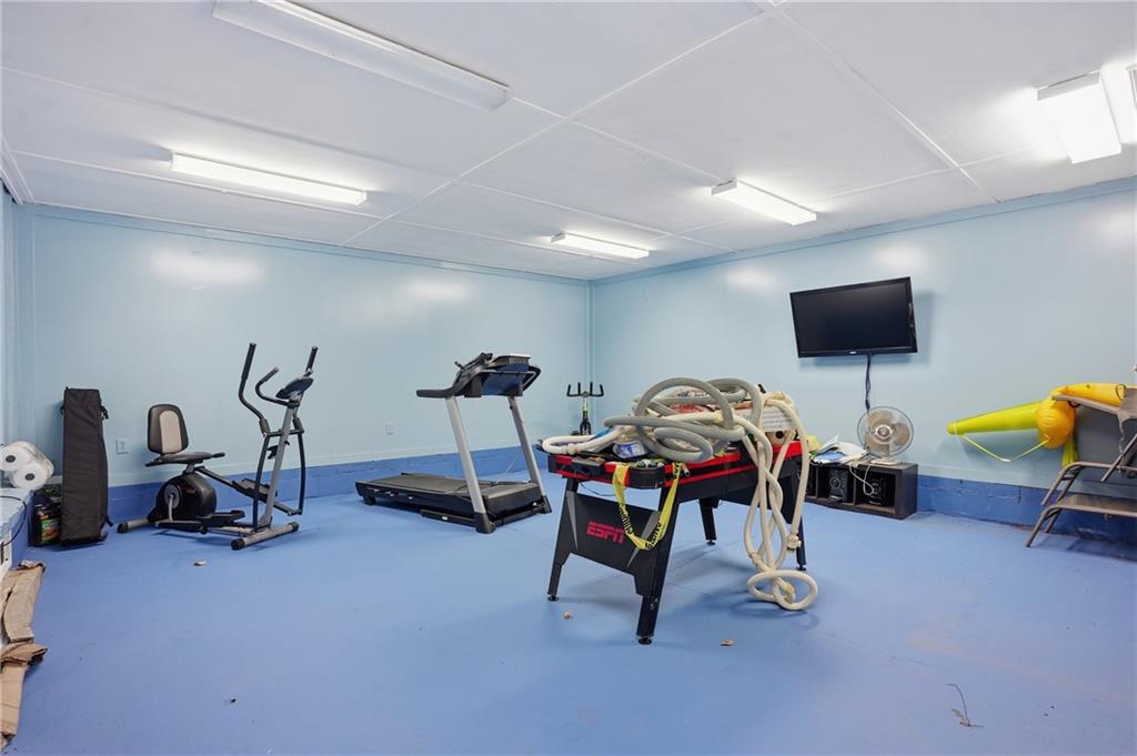 8926 Ashton Road Jonesboro, GA 30238 - Photo 20 of 32 a living room with furniture and a flat screen tv