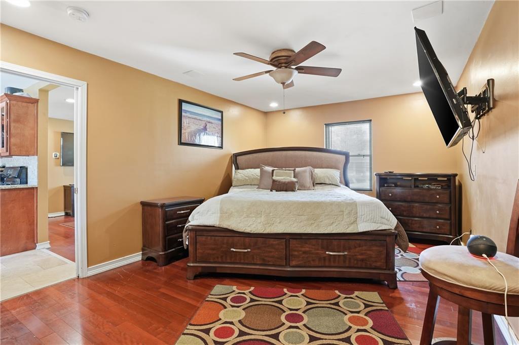 8926 Ashton Road Jonesboro, GA 30238 - Photo 9 of 32 a bedroom with a bed and wooden floor