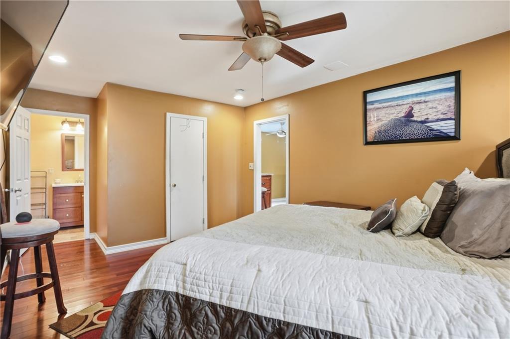 8926 Ashton Road Jonesboro, GA 30238 - Photo 10 of 32 a bedroom with a bed and a chandelier