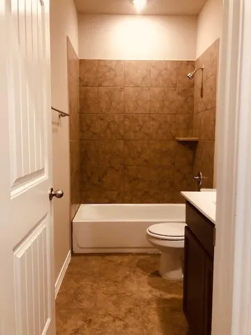 a bathroom with a toilet and a bathtub