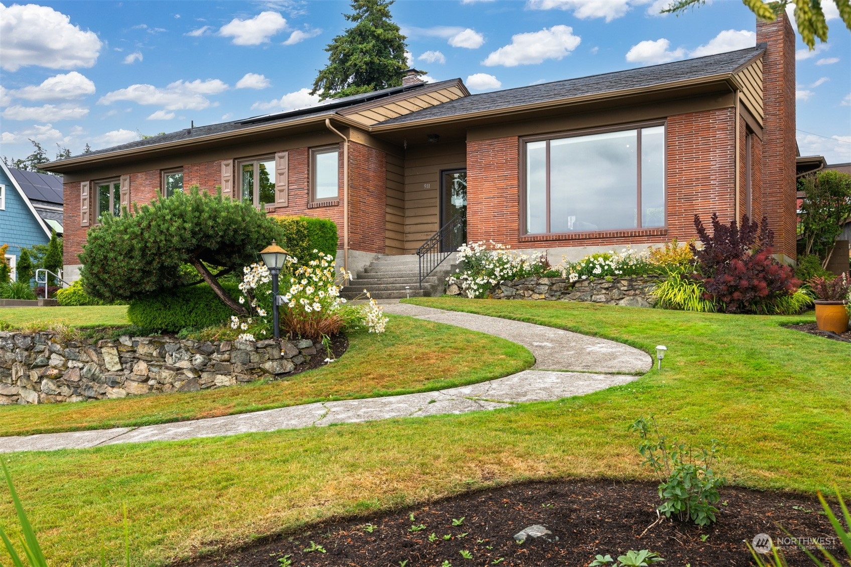 a front view of a house with garden