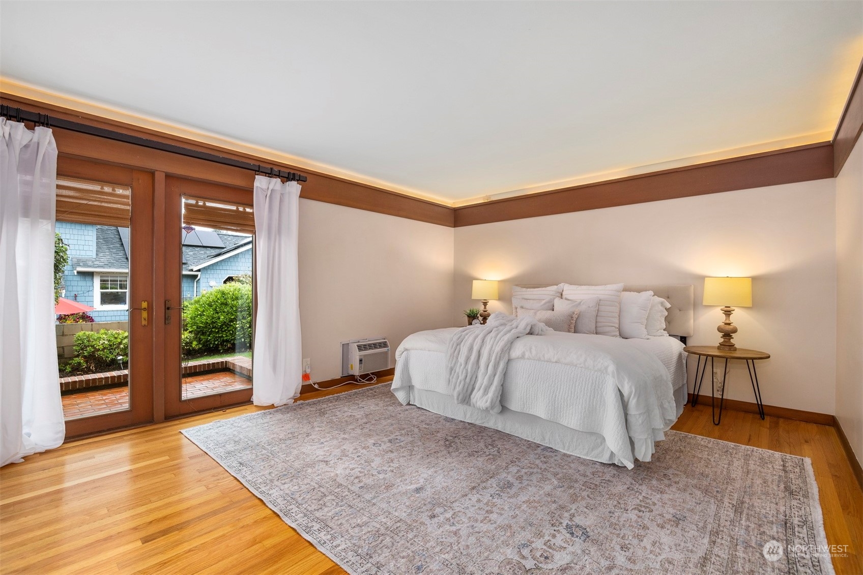 911 17th Street Bellingham, WA 98225 - Photo 11 of 39 a spacious bedroom with a bed and wooden floor