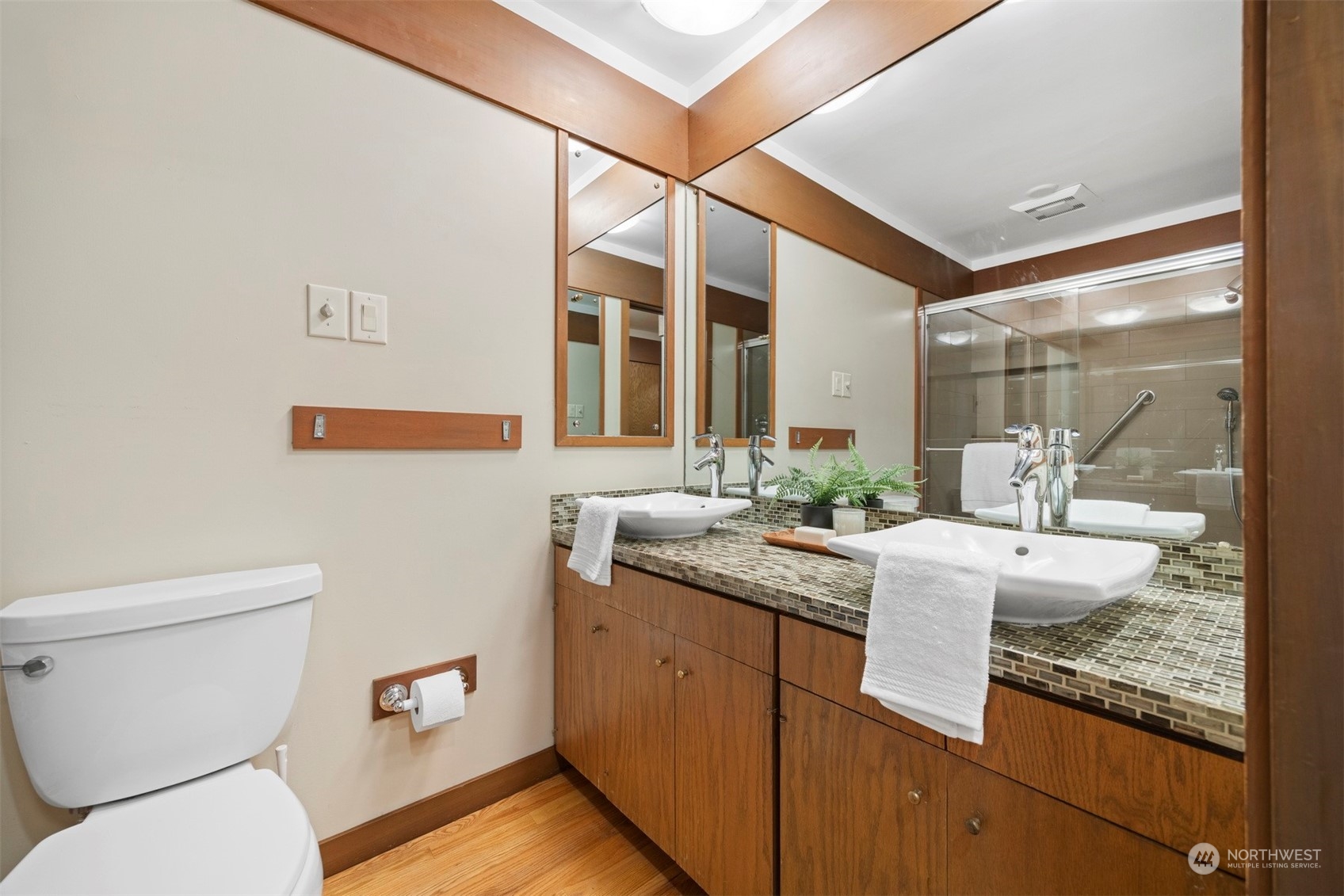 911 17th Street Bellingham, WA 98225 - Photo 13 of 39 a bathroom with a granite countertop sink a toilet and a mirror