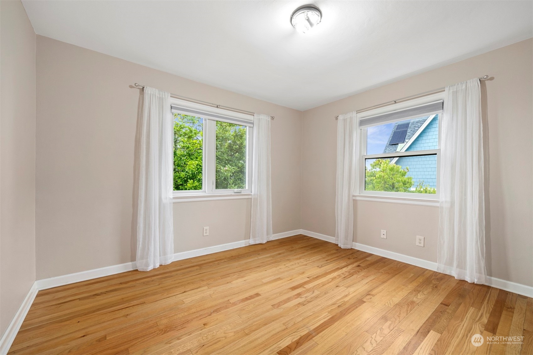 911 17th Street Bellingham, WA 98225 - Photo 14 of 39 a view of an empty room with wooden floor and a window