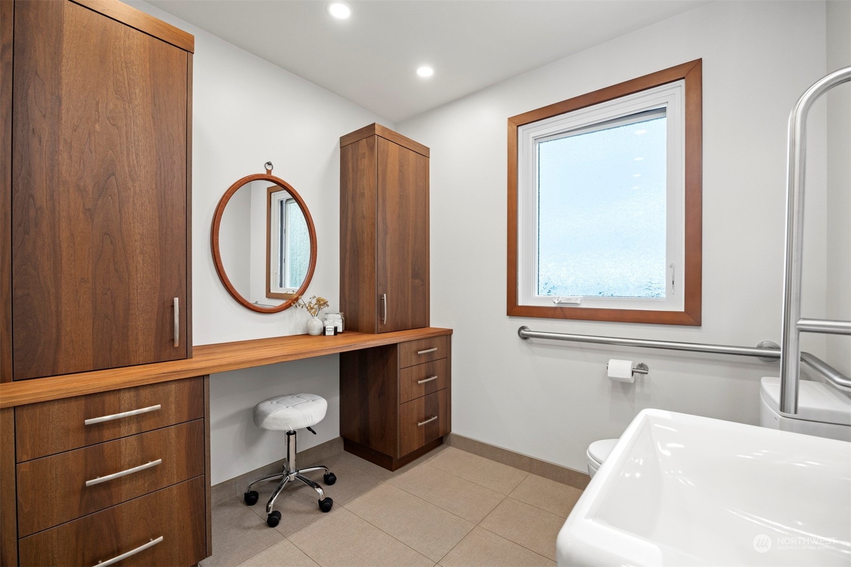 911 17th Street Bellingham, WA 98225 - Photo 17 of 39 a bathroom with a sink a mirror and a vanity