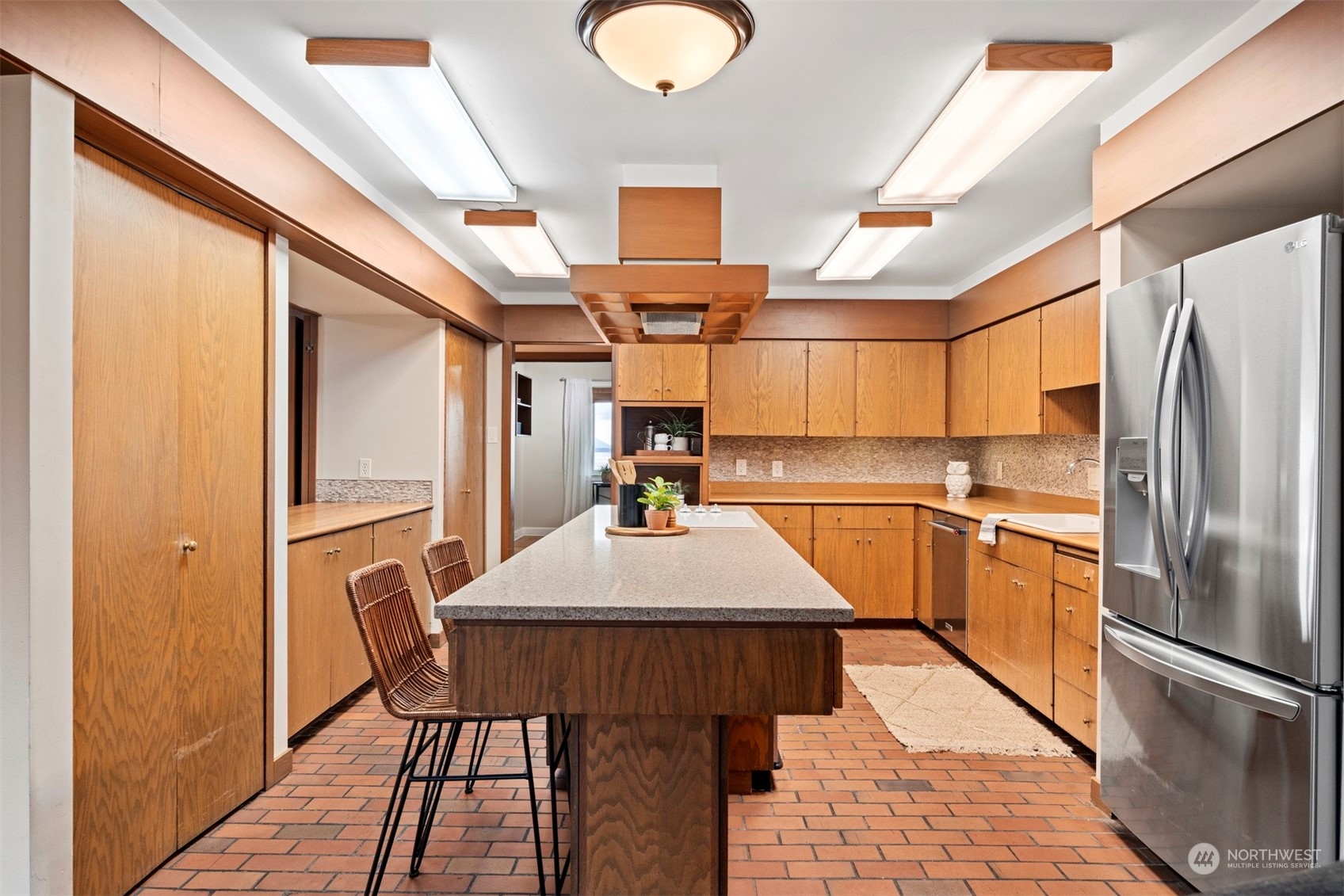 911 17th Street Bellingham, WA 98225 - Photo 26 of 39 a kitchen with stainless steel appliances a refrigerator and a stove top oven