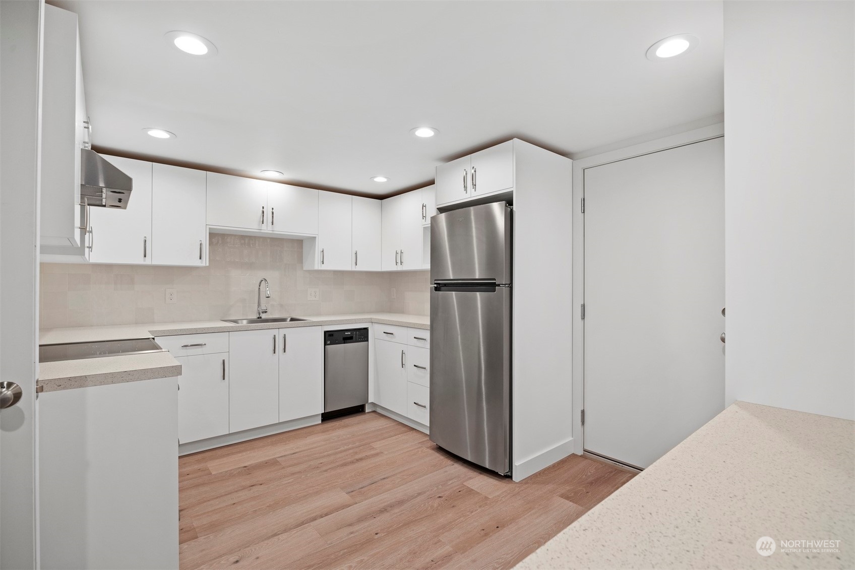 911 17th Street Bellingham, WA 98225 - Photo 37 of 39 a kitchen with a refrigerator and white cabinets