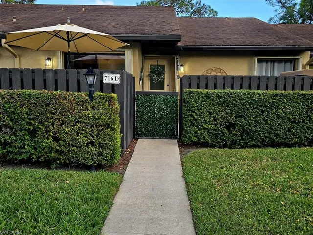 a view of a house with potted plants