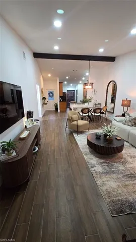 a living room with furniture and kitchen view