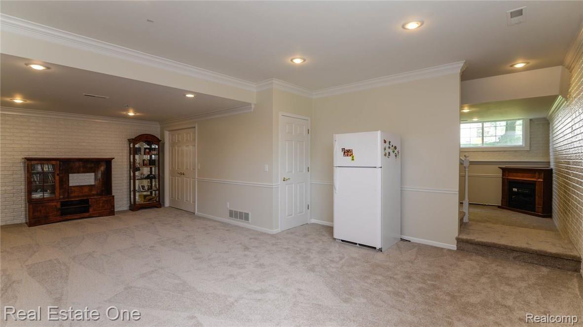 1824 Park Ridge Court Howell, MI 48843 - Photo 36 of 47 SPACIOUS BASEMENT RECREATION ROOM WITH LOTS OF STORAGE.