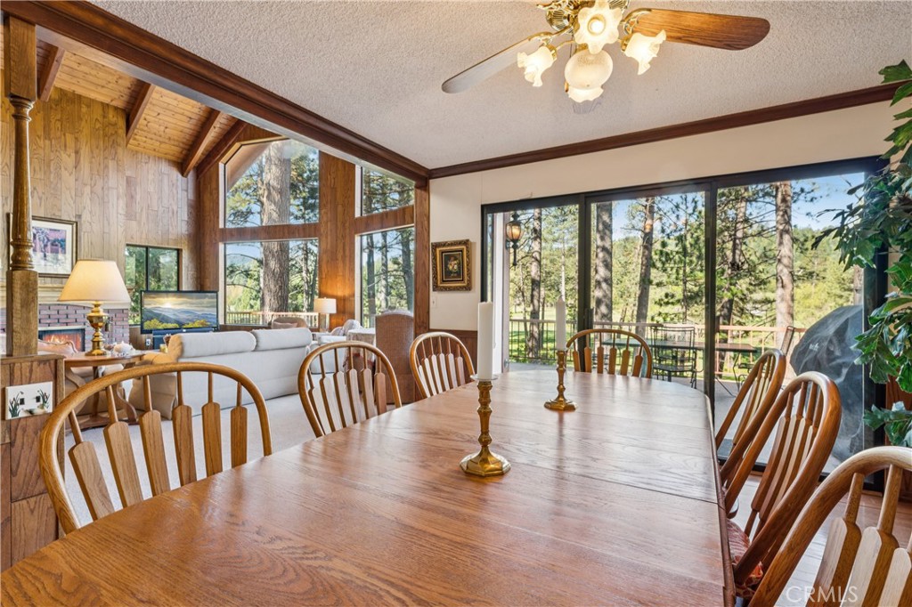 524 Golf Course Road Lake Arrowhead, CA 92352 - Photo 14 of 71 a view of a dining room with furniture large windows wooden floor and front door