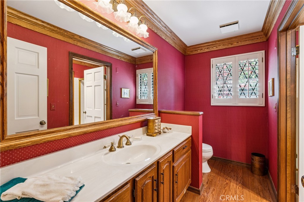 524 Golf Course Road Lake Arrowhead, CA 92352 - Photo 23 of 71 a bathroom with a sink a toilet a mirror and a window