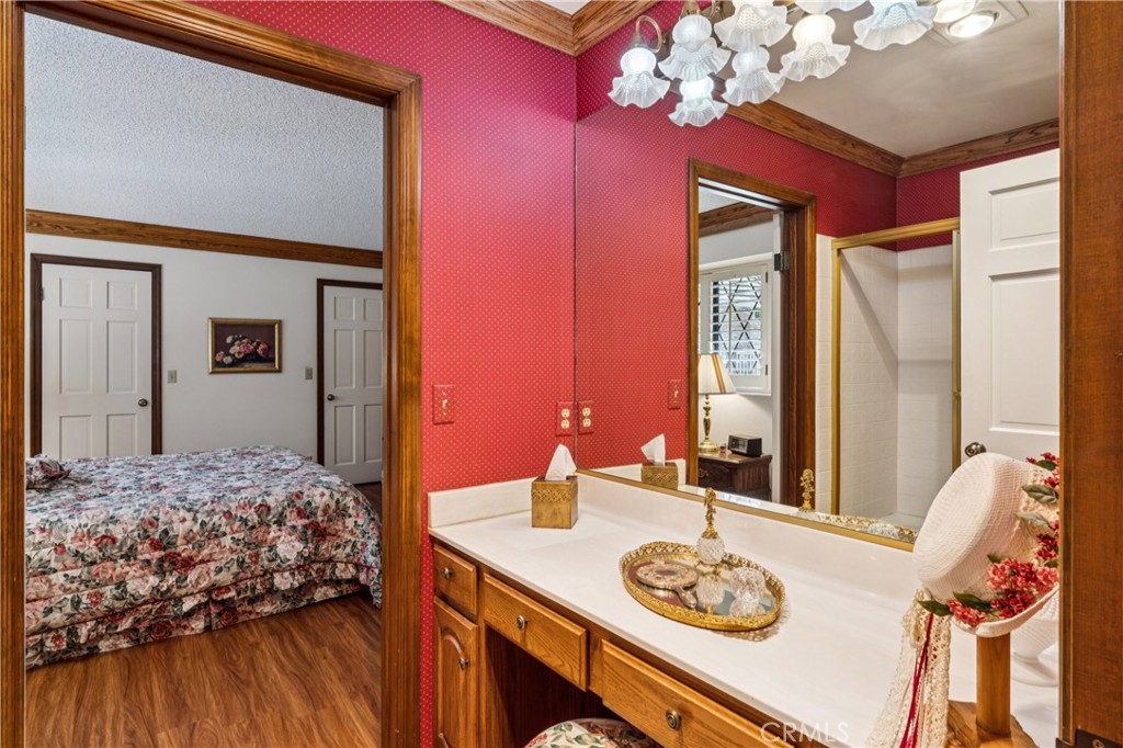 524 Golf Course Road Lake Arrowhead, CA 92352 - Photo 24 of 71 a bedroom with a bed and a dresser with mirror