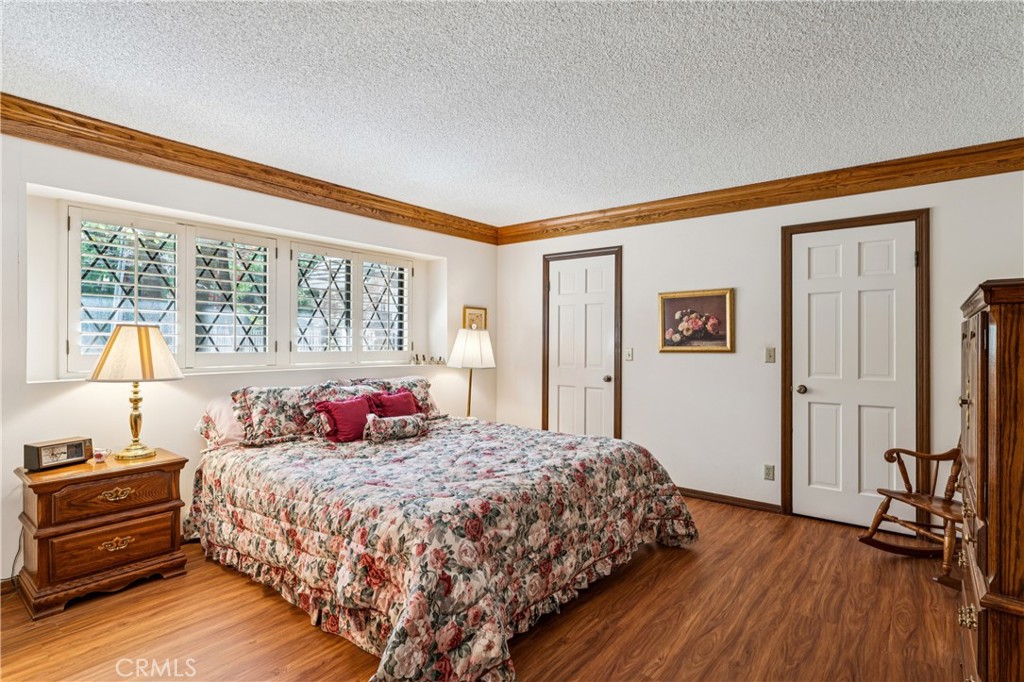 524 Golf Course Road Lake Arrowhead, CA 92352 - Photo 26 of 71 a bedroom with a bed and wooden floor