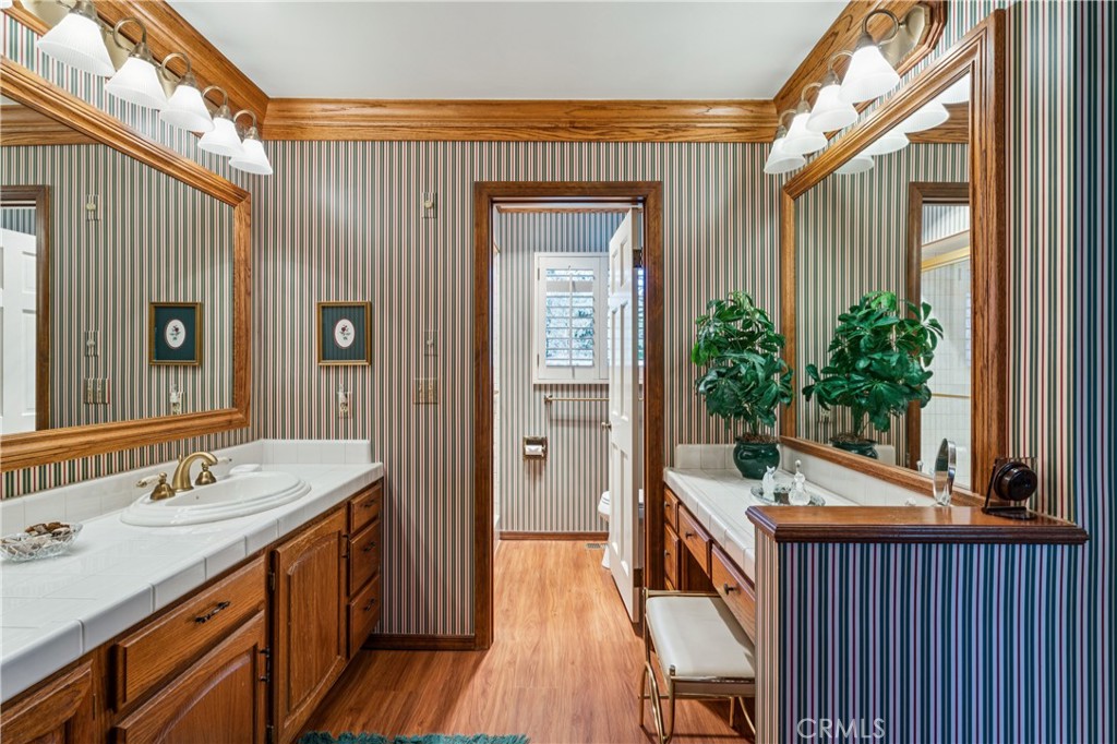 524 Golf Course Road Lake Arrowhead, CA 92352 - Photo 31 of 71 a bathroom with a sink a mirror and a potted plant