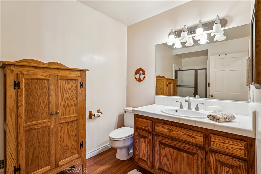 524 Golf Course Road Lake Arrowhead, CA 92352 - Photo 48 of 71 a bathroom with a sink a toilet and mirror