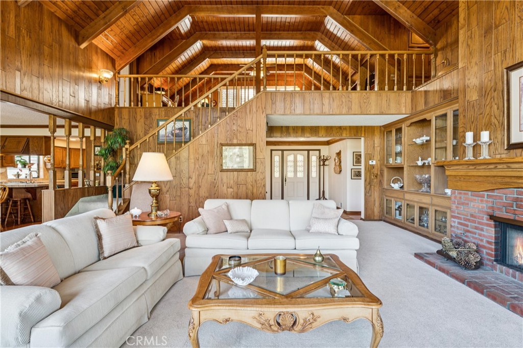 524 Golf Course Road Lake Arrowhead, CA 92352 - Photo 9 of 71 a living room with furniture a fireplace and a chandelier