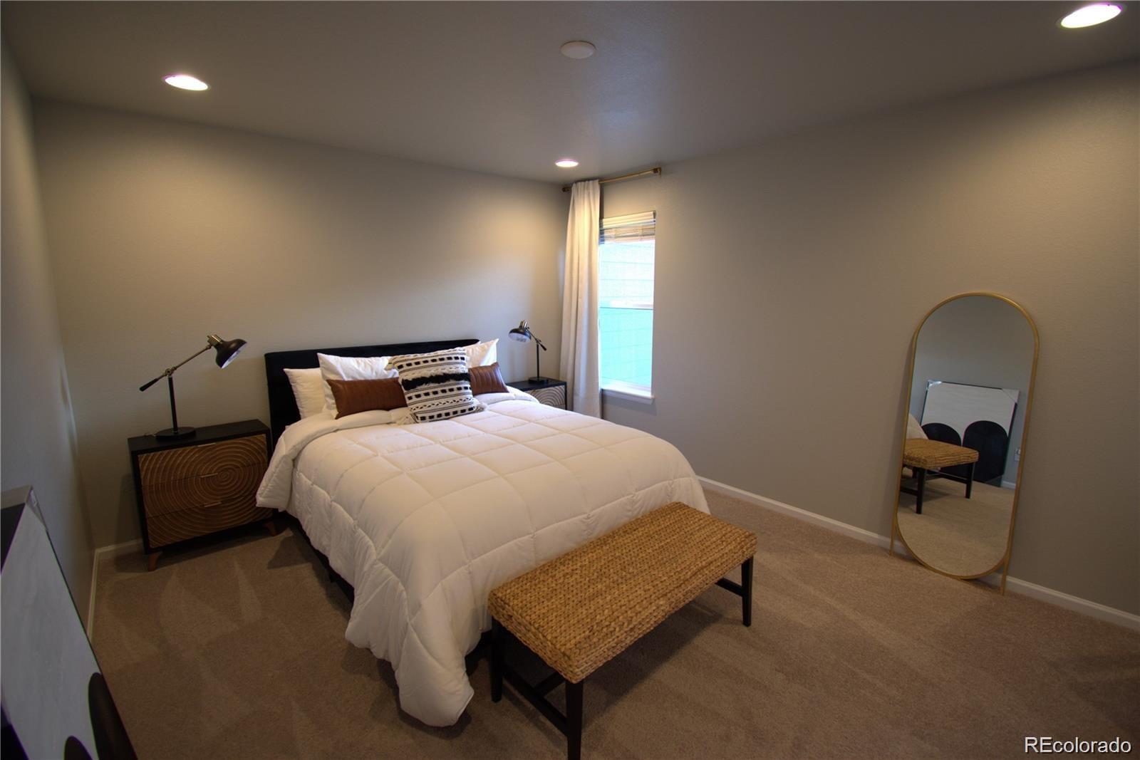 6435 North Dunkirk Street Denver, CO 80249 - Photo 11 of 12 a bedroom with a bed and window