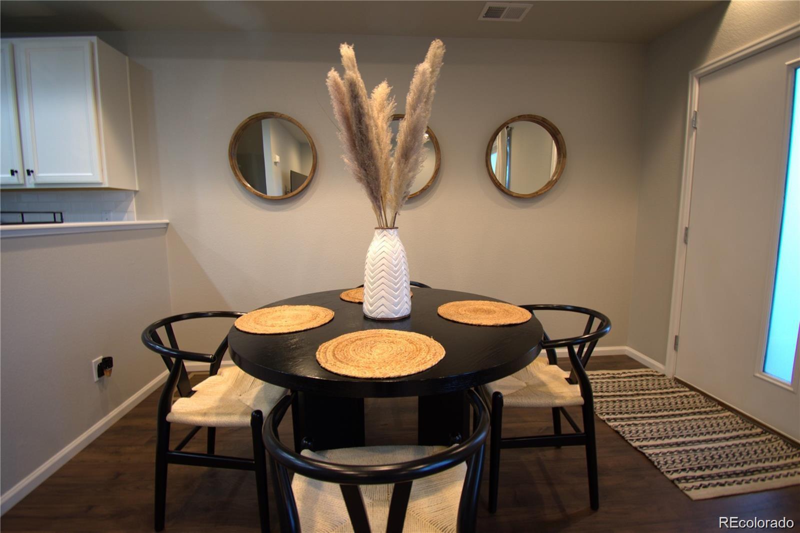 6435 North Dunkirk Street Denver, CO 80249 - Photo 5 of 12 a view of a dining room with chairs and wooden floor