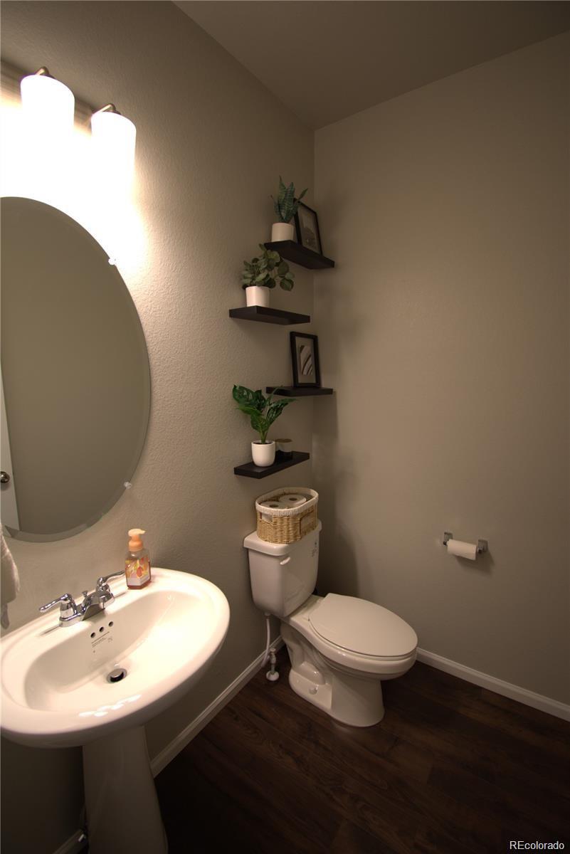6435 North Dunkirk Street Denver, CO 80249 - Photo 7 of 12 a bathroom with a sink toilet and a mirror