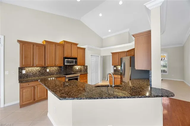 a kitchen with stainless steel appliances granite countertop a granite counter tops and a stove