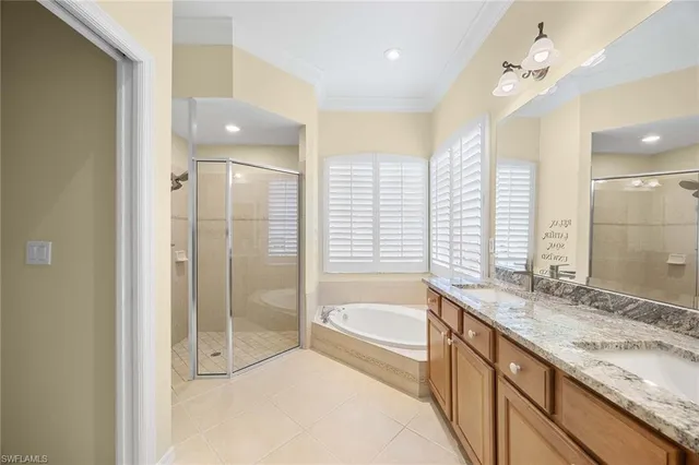 a spacious bathroom with a granite countertop tub sink shower and a mirror