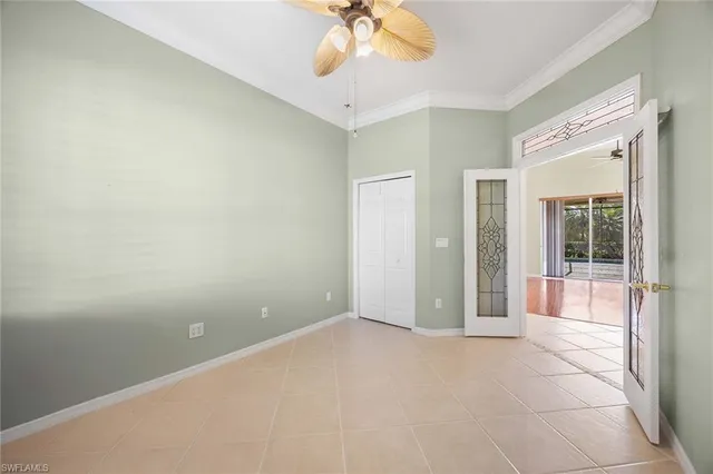 en empty room with window and a ceiling fan