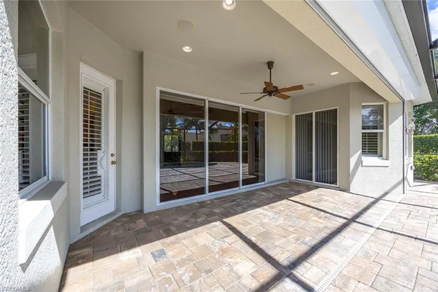 a spacious bedroom with a large bed and a large window