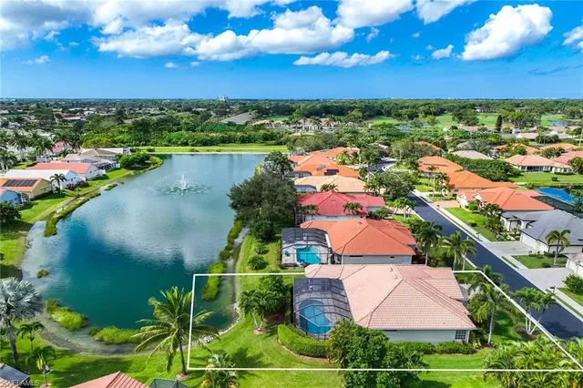 an aerial view of residential houses with outdoor space and street view
