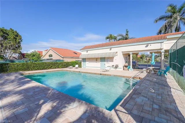 swimming pool view with a seating space
