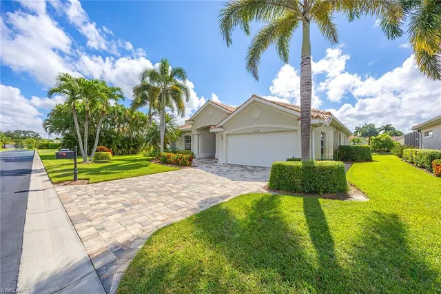 a view of a backyard with a garden and palm trees