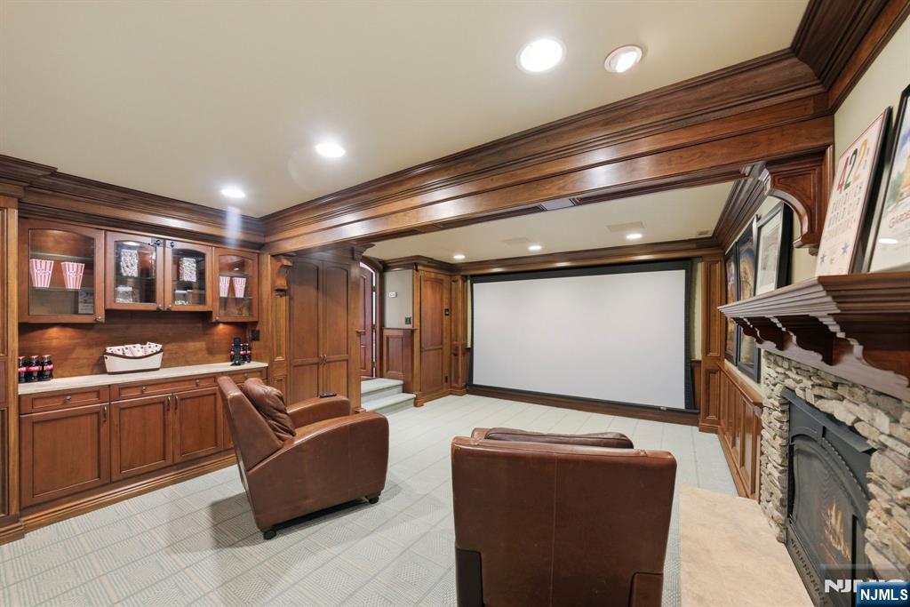 203 Heights Road Ridgewood, NJ 07450 - Photo 32 of 41 a living room with fireplace furniture and a projector screen