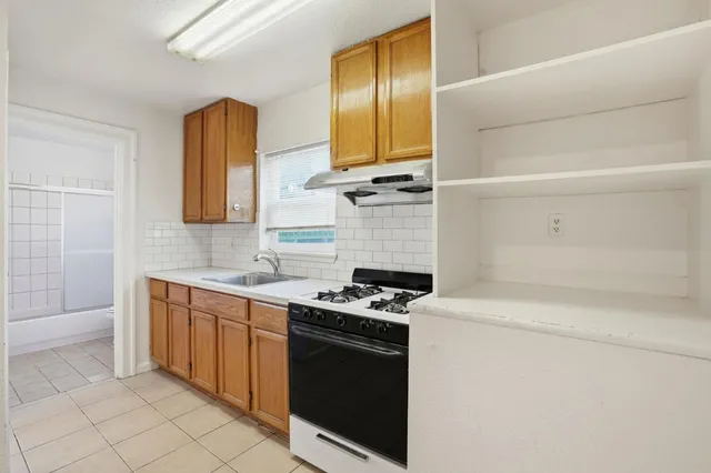 a kitchen with a sink and cabinets