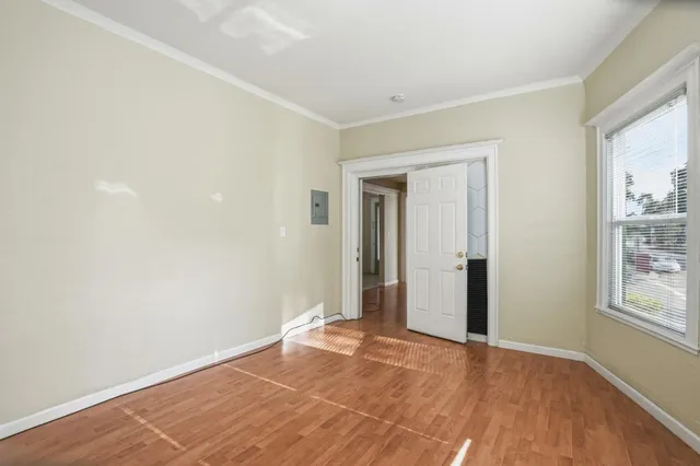 an empty room with windows and closet